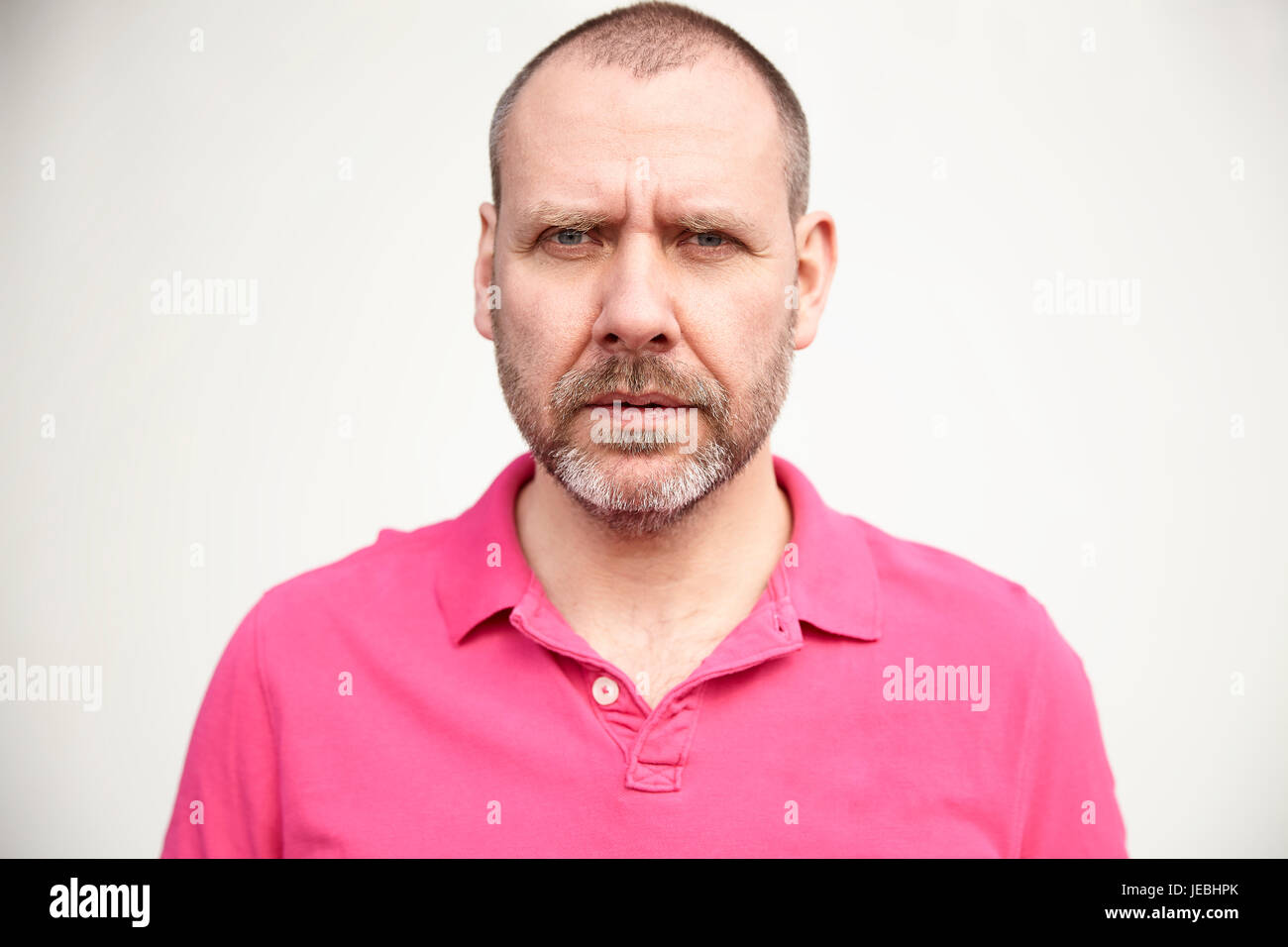 Mature man in pink shirt hi-res stock photography and images - Alamy