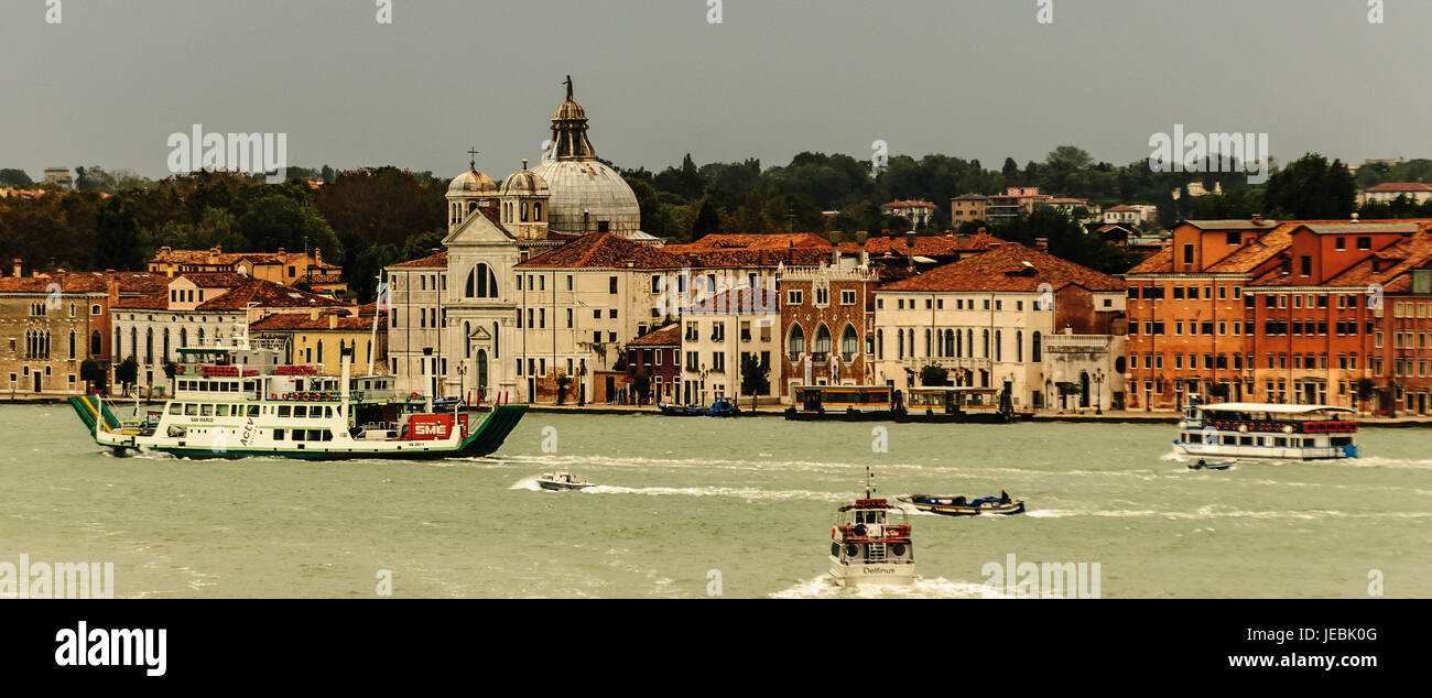 Traffic on the Grand Canal in Venice Italy, early morning. There are ferries, water taxis barges,police boats. All traffic is on the water no streets Stock Photo