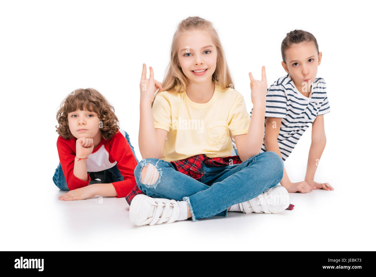 Three children sitting on floor hi-res stock photography and images - Alamy