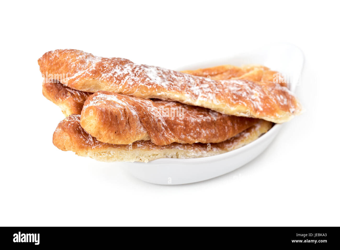 closeup of some fartons, typical pastries of Valencia, Spain, in a white ceramic bowl on a white background Stock Photo