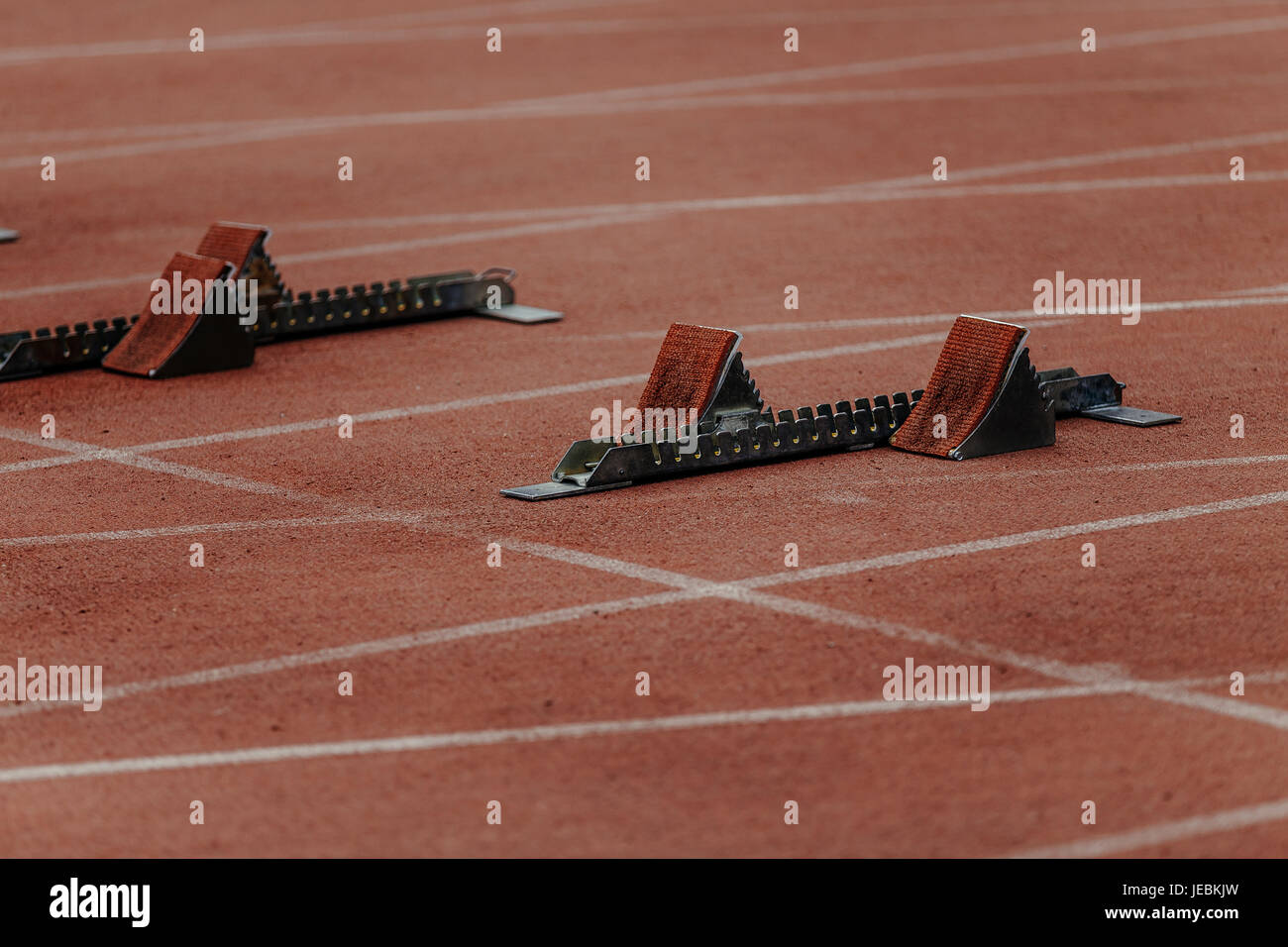 starting blocks on start line of sprint 100 meters Stock Photo