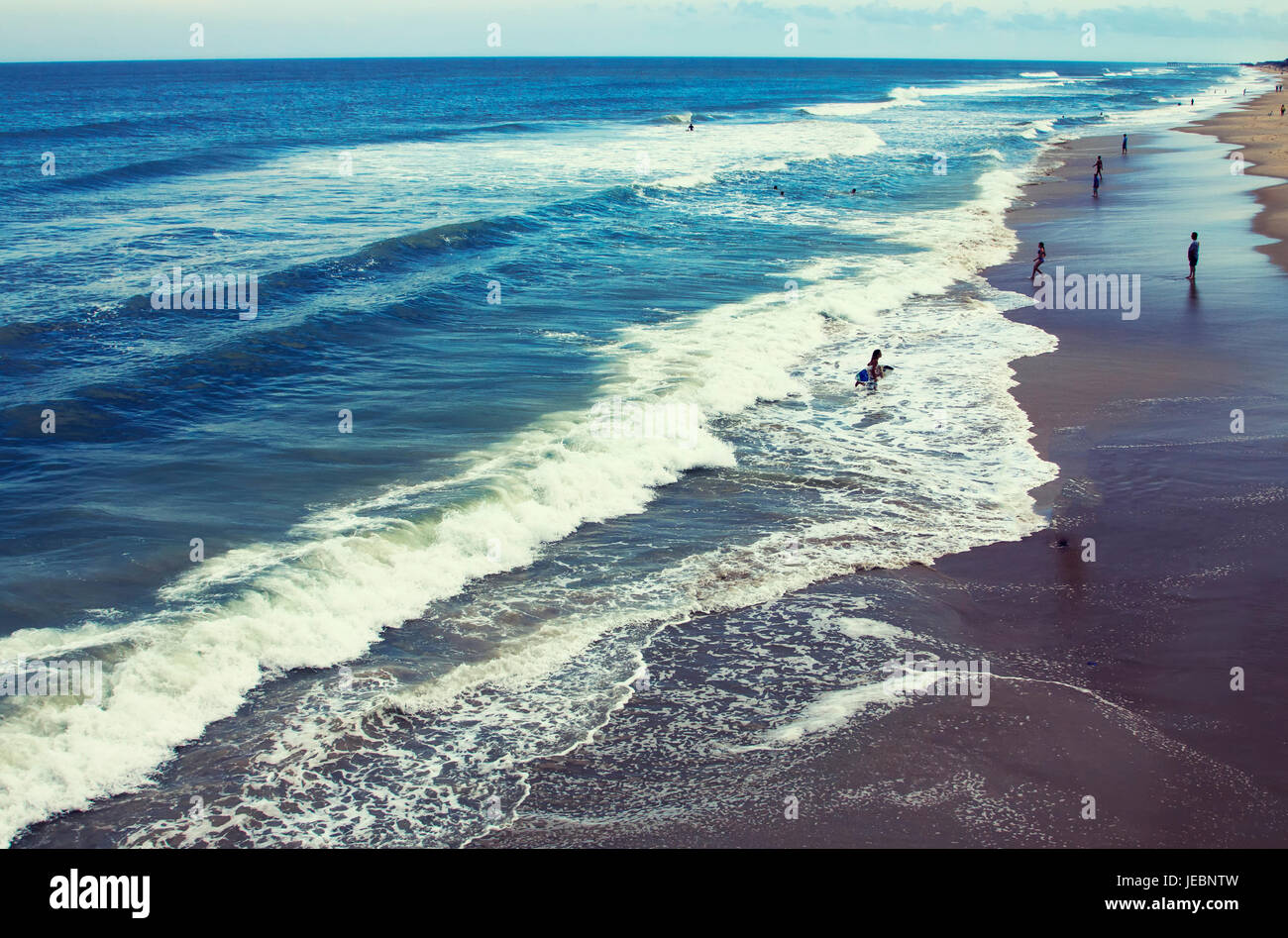 People playing in surf at beach in Nags Head North Carolina Outer Banks