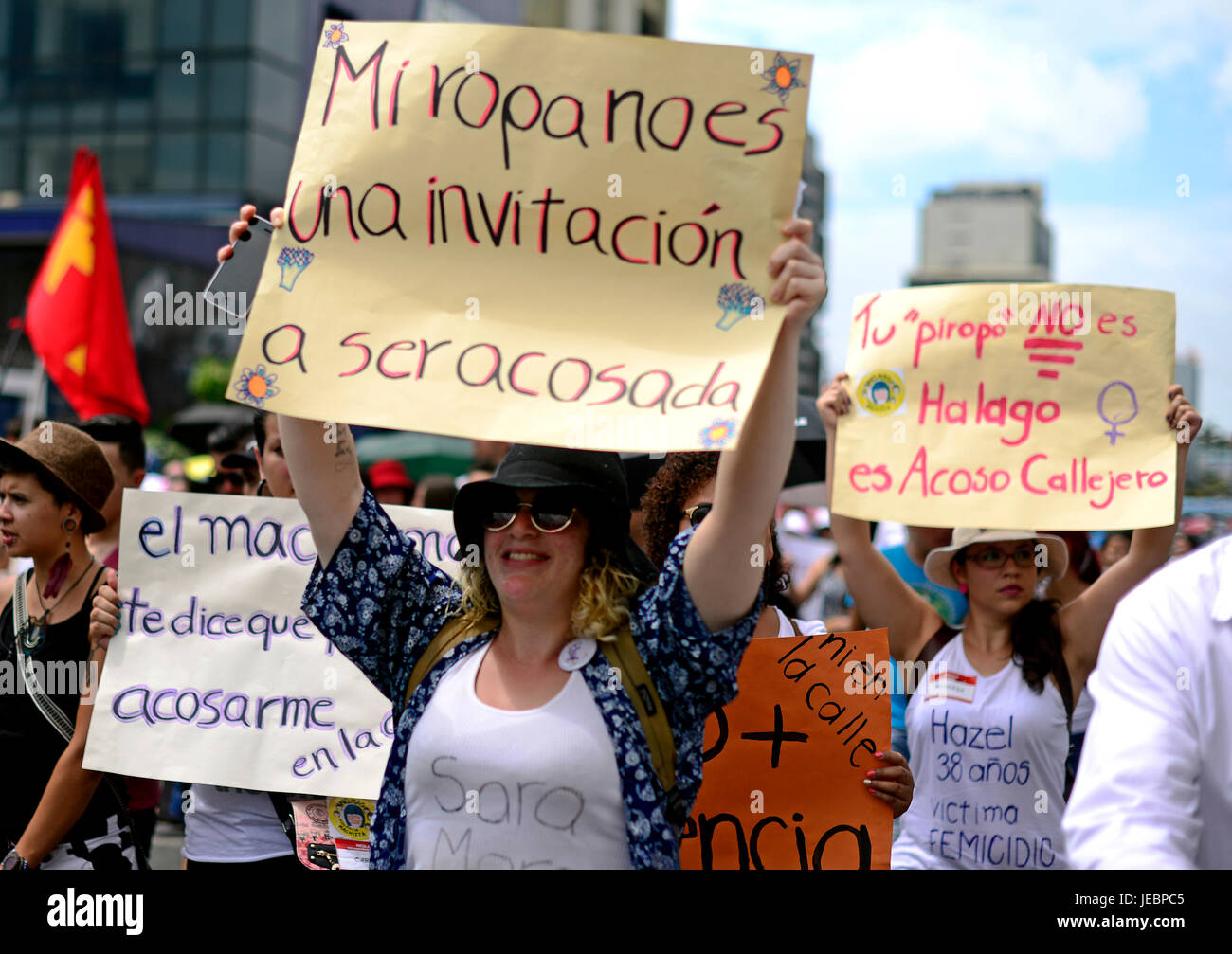 A woman raises a sign that says 