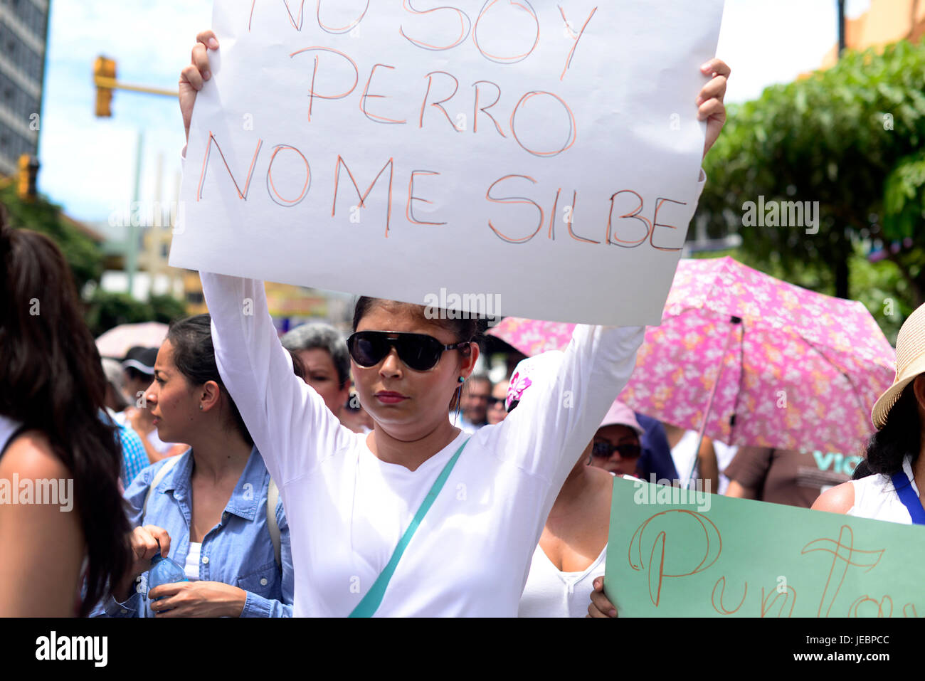 A woman carries a sign that says 