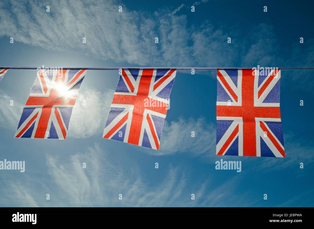 British flags bunting against blue sky Stock Photo Alamy