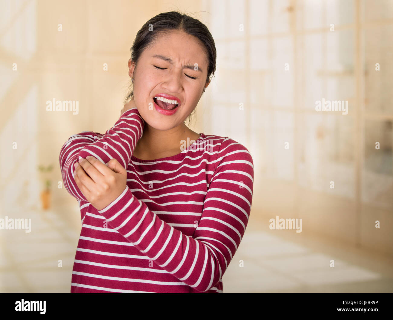 Young hispanic woman posing for camera showing signs of neck pain