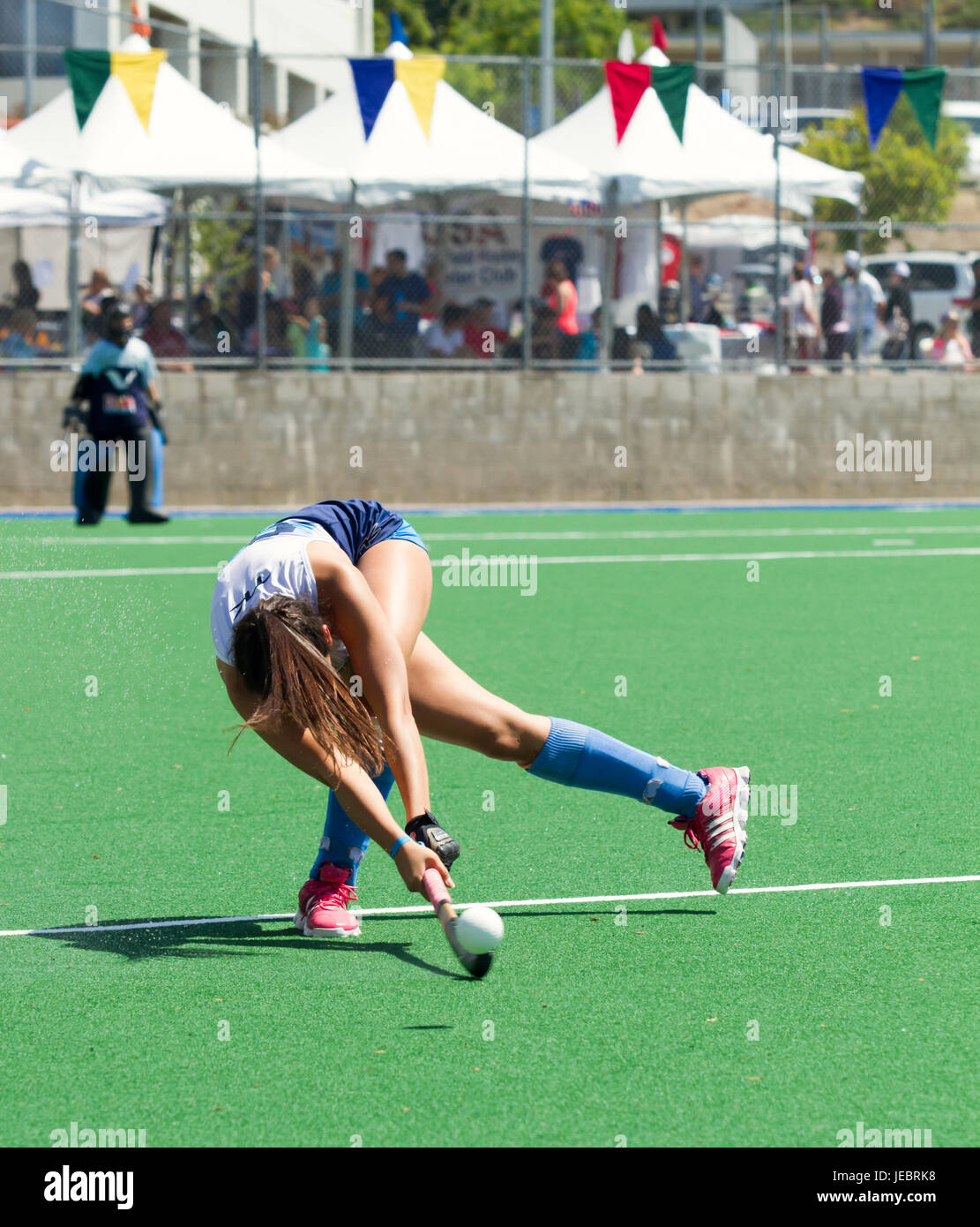 Unidentified field hockey player drives the puck down field Argentina