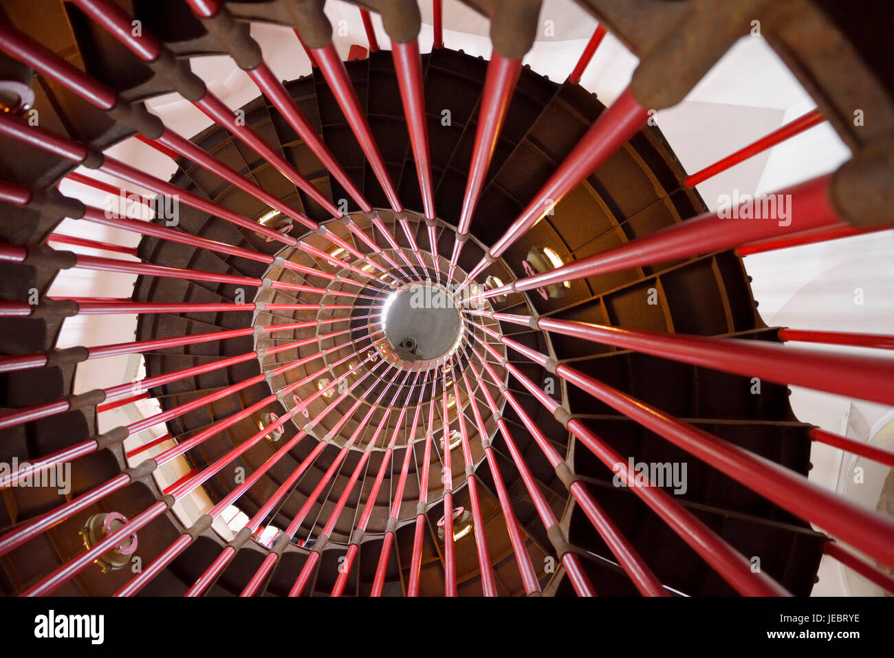View up the steel double helix spiral staircase at the historic Ljubljana Castle tower on Castle Hill with red bar posts Ljubljana Slovenia Stock Photo