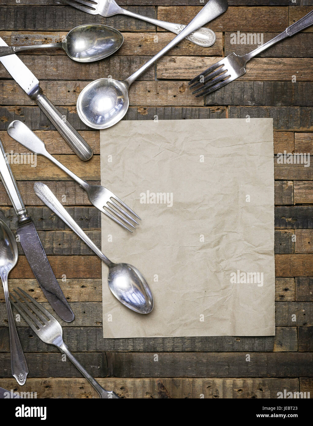 Vintage antique spoons forks and knifes on old wooden background flat lay food blog instagram mockup Stock Photo