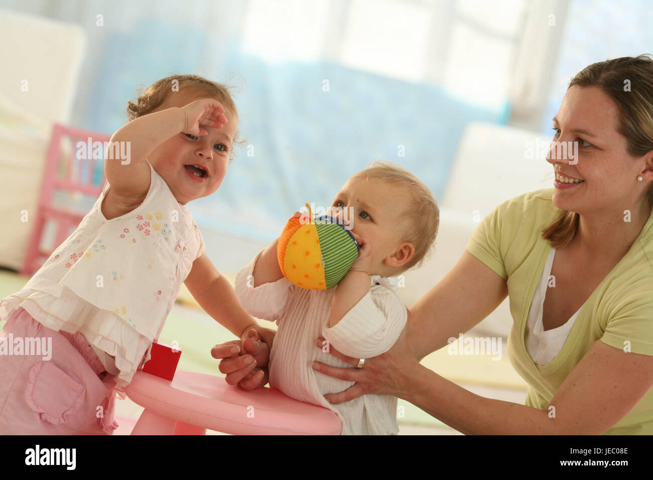 Babies, 9 months, mother, ball, play, get up, ball, dressed, blond, jealousy, discoveries, friends, reach, group, Indoor, boy, facial play, girl, play, toys, stand, fight, weep, baby, person, woman, Stock Photo