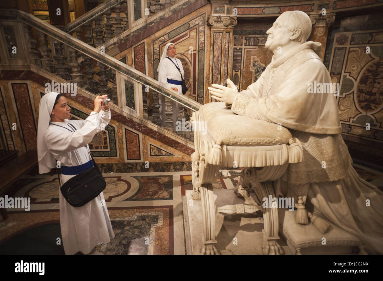 Italy, Rome, church Santa Maria Maggiore, inside, nun takes a photo of statue Pius IX, Stock Photo