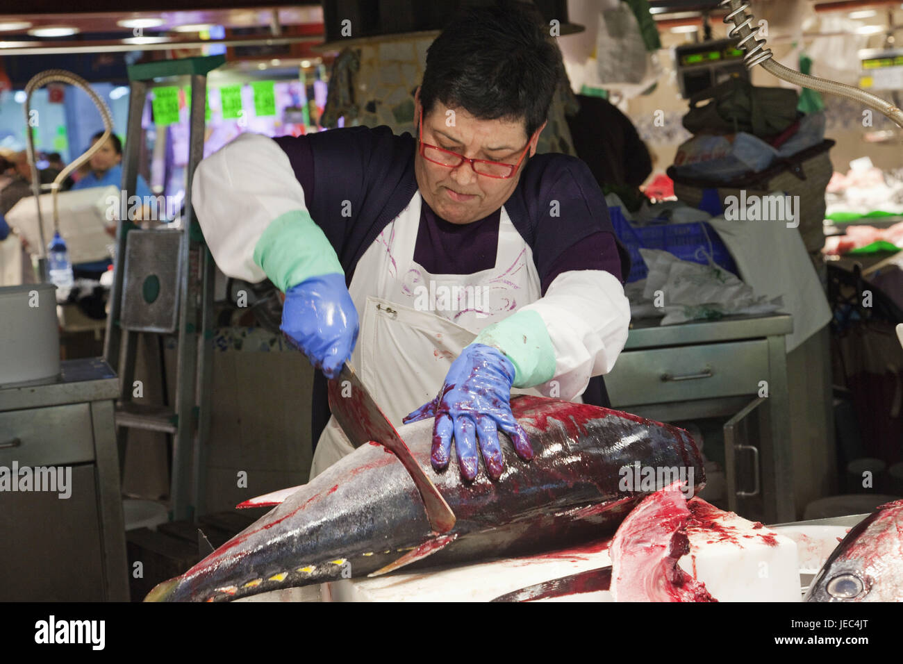Spain, Barcelona, Ramblas, Mercat La Boqueria, fish seller, cuts tuna, Stock Photo