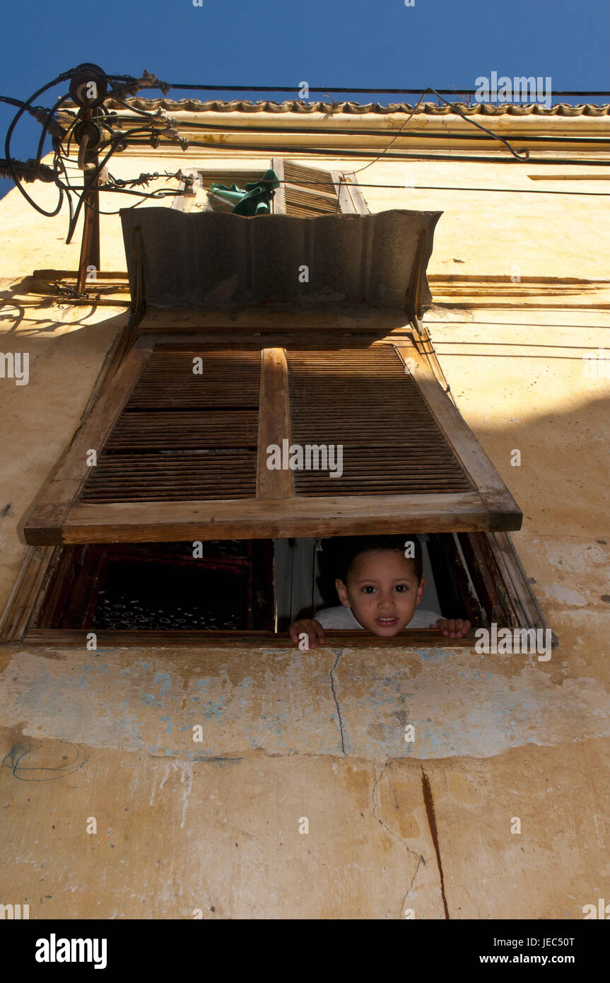 Boy looks under a shutter out in the UNESCO-world cultural heritage the kasbah, Old Town of Algiers, capital of Algeria, Africa, Stock Photo