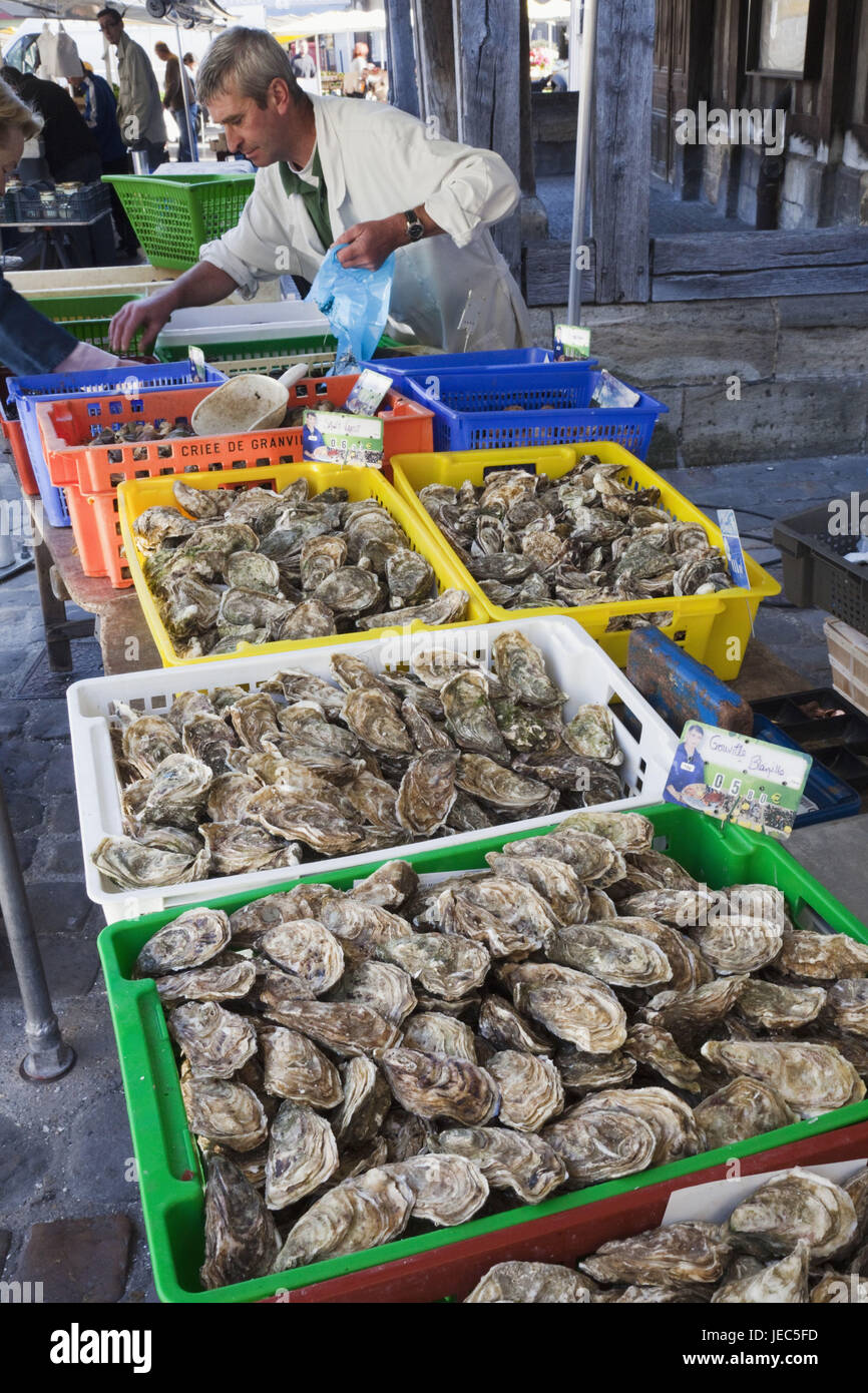 France, Normandy, Honfleur, market stall, oysters, sellers Stock Photo