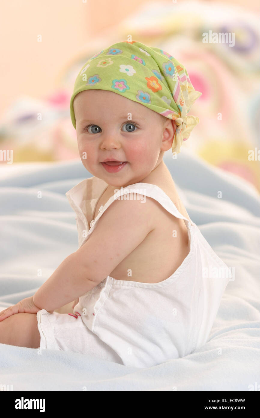Baby, headscarf, smile, sit, people, child, infant, girl, headgear, cloth, overalls, happily, cheerfully, lighthearted, sweetly, bed, childhood, child portrait, inside, Stock Photo