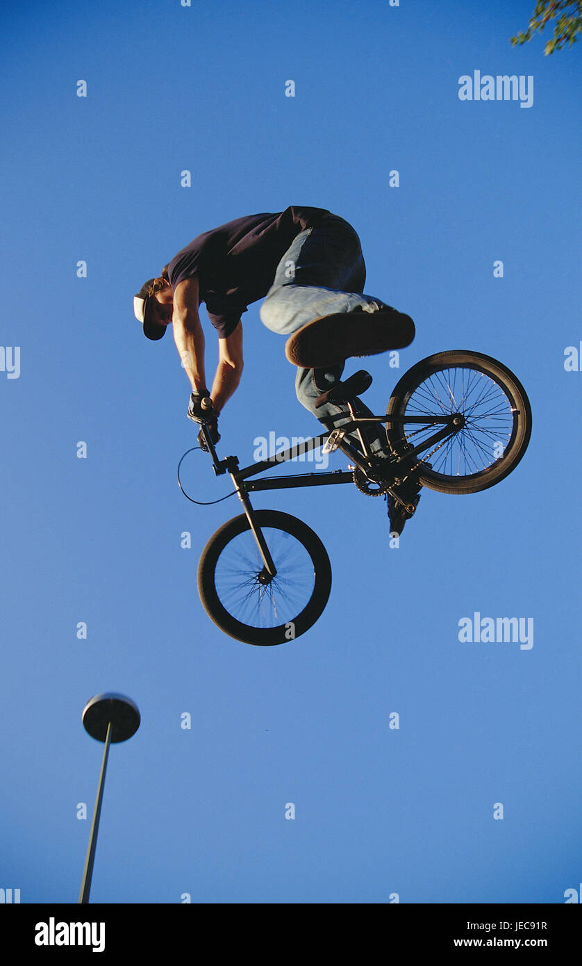 Teenager, BMX bike, crack, sky, sport, cycling, BMX, bicycle, person, man,  young, young person, skills, skill, St. of art, motion, caper, Freestyle,  Dirtjump, Tabletop, fun sport, below shot, outside Stock Photo -