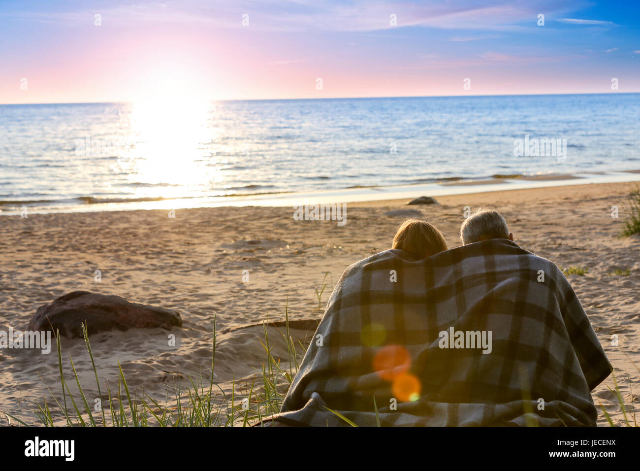Portrait of a senior couple at sea at sunset Stock Photo - Alamy