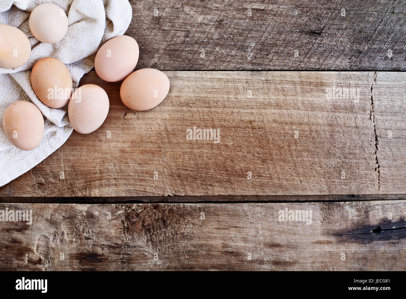 Farm fresh organic brown chicken eggs from free range chickens over a