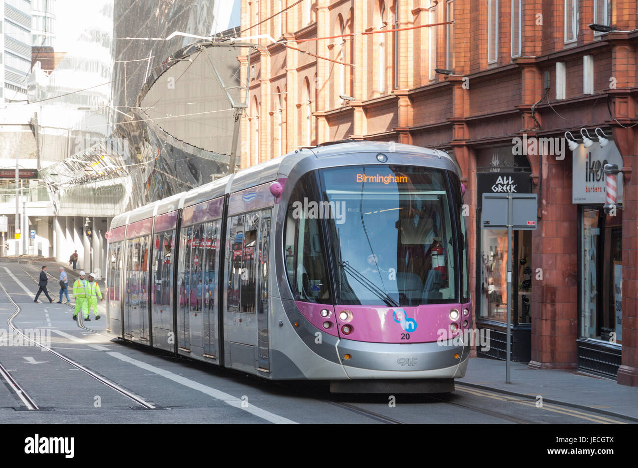 A Midland Metro Urbos 3 tram in Stephenson Street, central Birmingham, England. Entrance to New Street Rail Station in background. Stock Photo