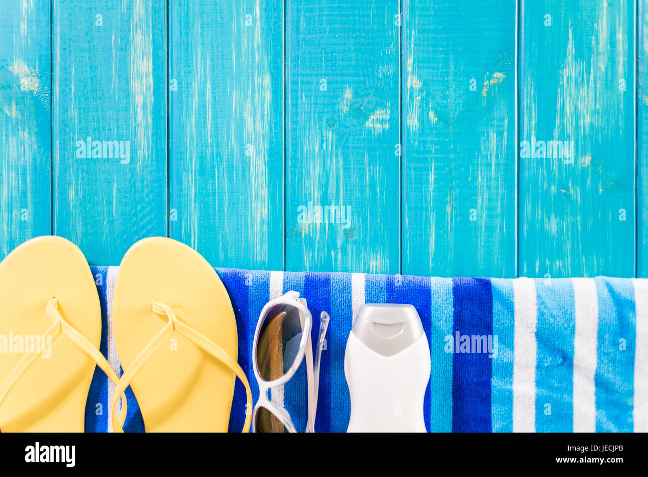Bright women's flip flops and beach towel Stock Photo - Alamy