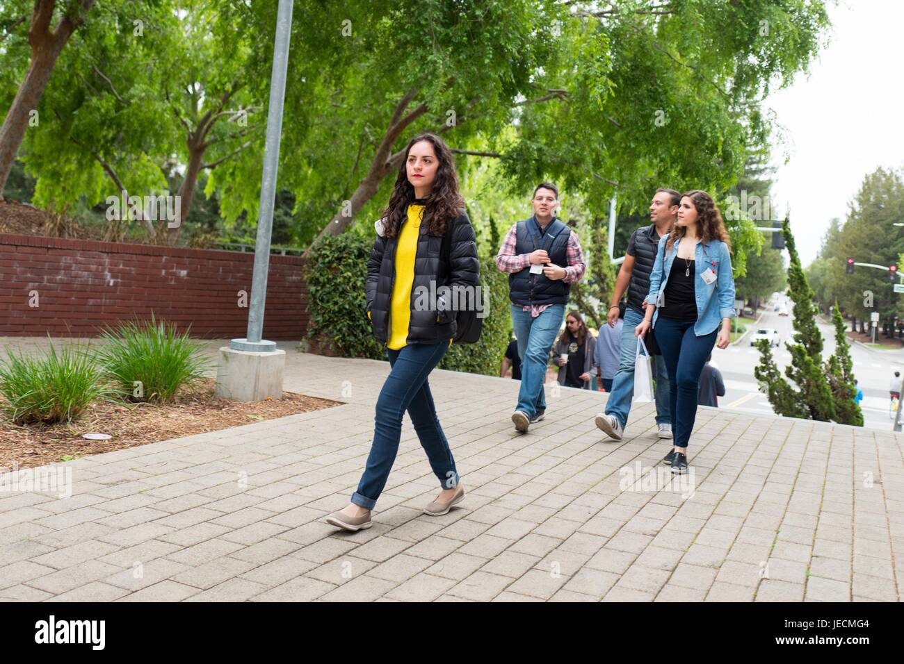 Google Inc employees and visitors, including several females, walk through the Googleplex, headquarters of Google Inc in the Silicon Valley town of Mountain View, California, April 7, 2017. Diversity in hiring is an important topic in Silicon Valley, especially providing equal opportunities for females in technology. Stock Photo