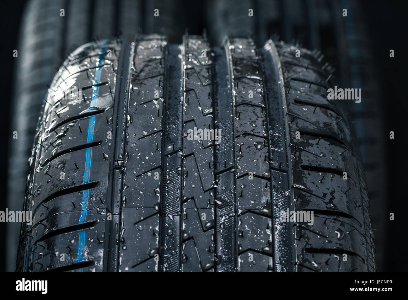 Stack of brand new high performance car tires on clean highkey white