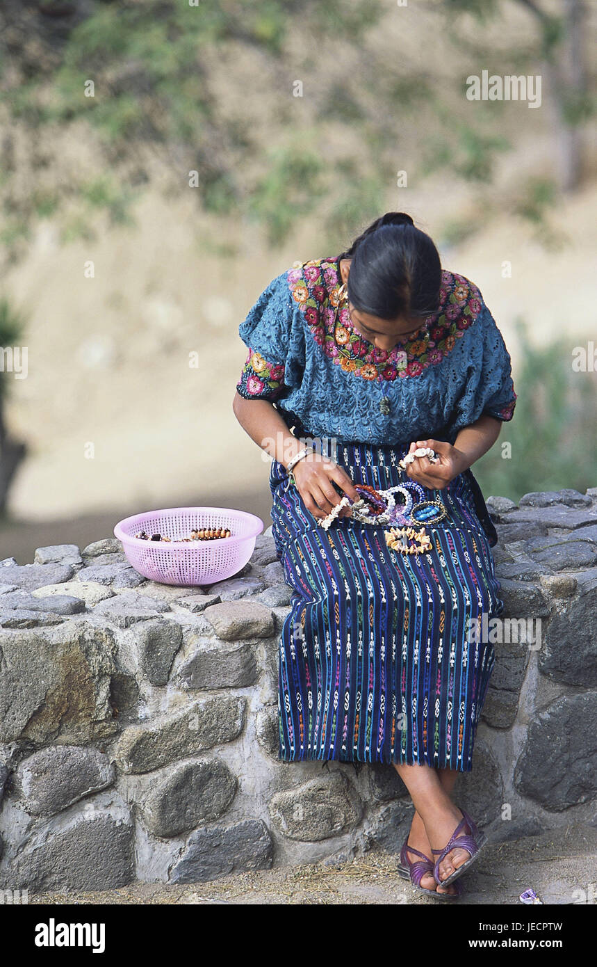 Guatemala, Panajachel, defensive wall, woman, sit, thread sales, souvenirs, bracelets, no model release, Central America, Latin America, destination, person, Maya, tribe, clothes, traditionally, national costume, outside, manual labour, handicraft, cords, pearls, whole body, Stock Photo