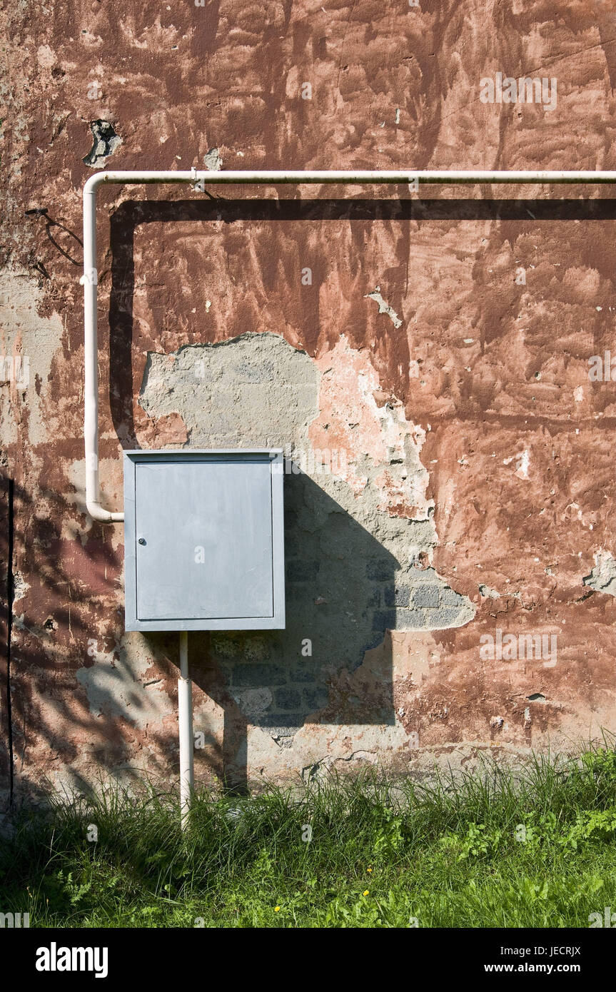 New junction box before old defensive wall, medium close-up, detail, Stock Photo
