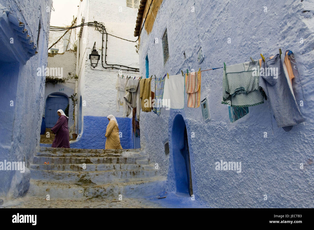 Morocco, Chefchaouen, lane, house facades, rope, laundry, women, no model release, Africa, house, building, house defensive walls, defensive walls, residential houses, facades, blue, architectural style, architecture, place of interest, person, stairs, clothesline, washday, laundry pieces, dry, outside, Stock Photo
