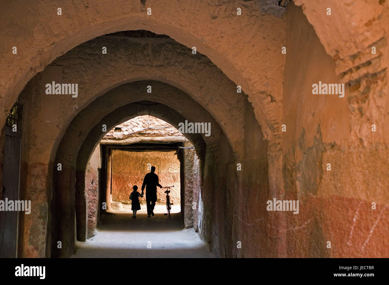 Morocco, Marrakech, Medina, passage, curves, people, silhouette, Africa, North Africa, place of interest, town, part of town, Old Town, architecture, old, historically, walk, person, light, anonymity, unrecognized, whole body, man, father, child, bicycle, push, Stock Photo