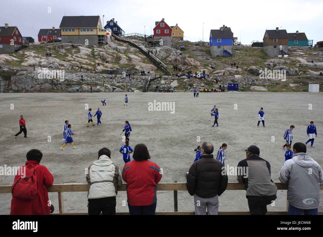 Greenland, Disco Bay, Ilulissat, town view, timber houses, football field, player, spectator, no model release, Western Greenland, outside, the Arctic, coast, town, residential houses, architecture, timber houses, brightly, field, sports field, sport, sport, person, football player, football match, football, Stock Photo