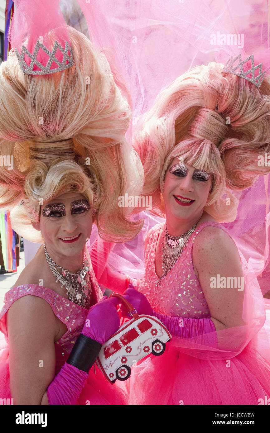 England, London, Gay Pride Parade, men, two, pink clothes, medium close-up, half portrait, town, festival, save, festival, Pride festival, Homosexual, pink, wigs, panels, camera view, person, made up, smile, curled, Stock Photo