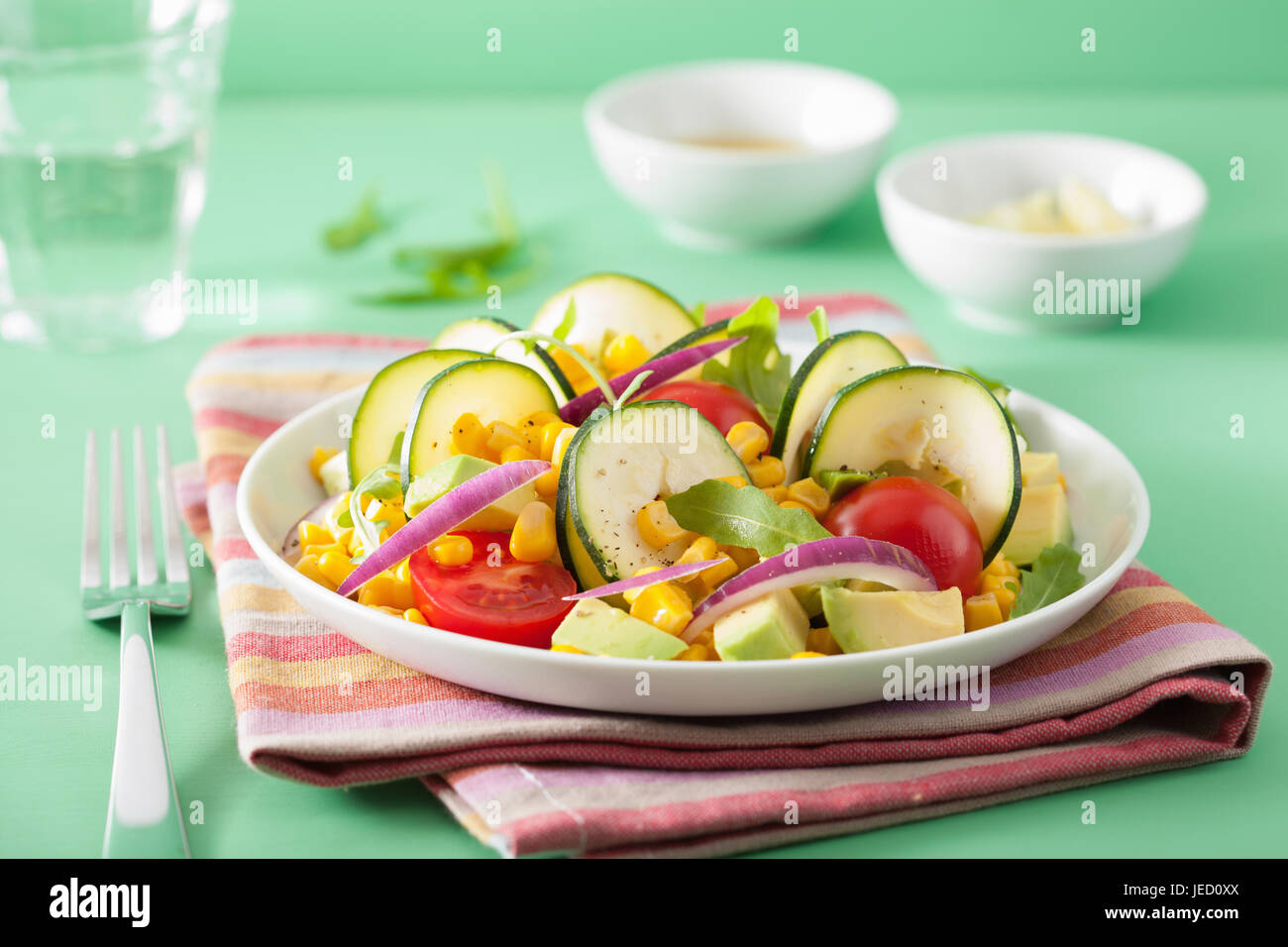 spiralized courgette salad with sweetcorn tomato avocado, healthy vegan meal Stock Photo