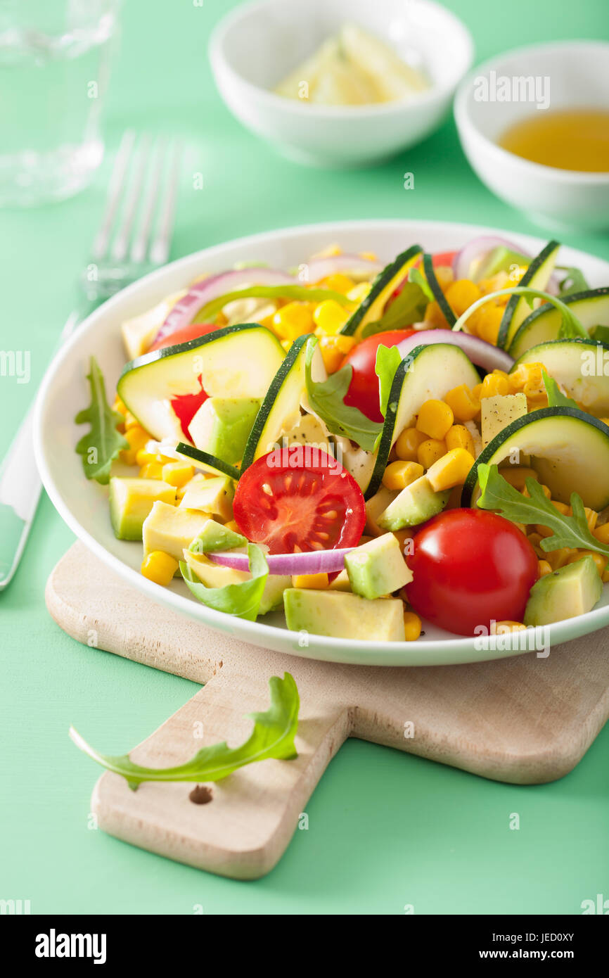 spiralized courgette salad with sweetcorn tomato avocado, healthy vegan meal Stock Photo