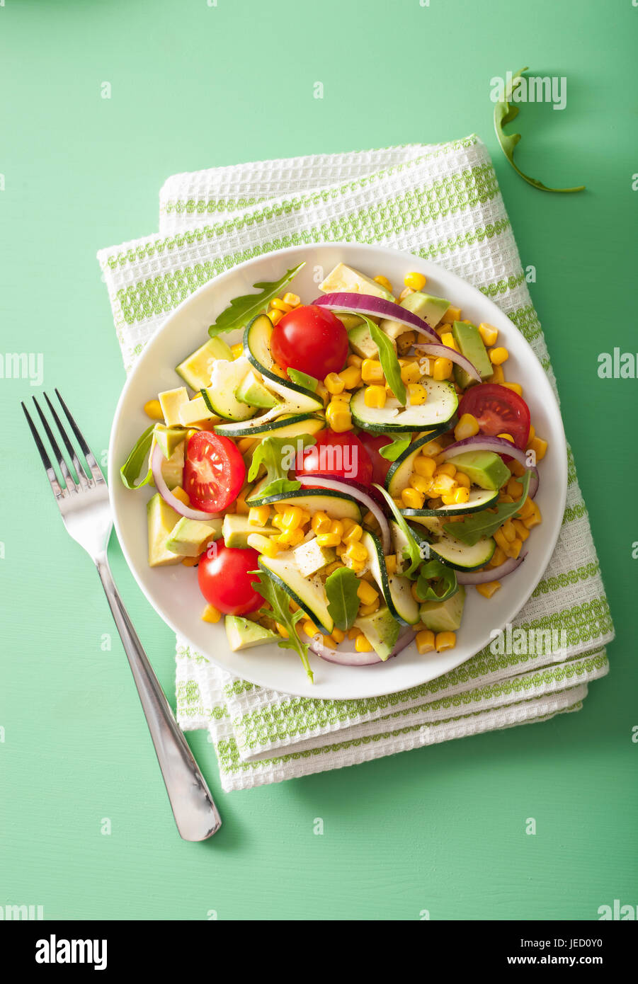 spiralized courgette salad with sweetcorn tomato avocado, healthy vegan meal Stock Photo