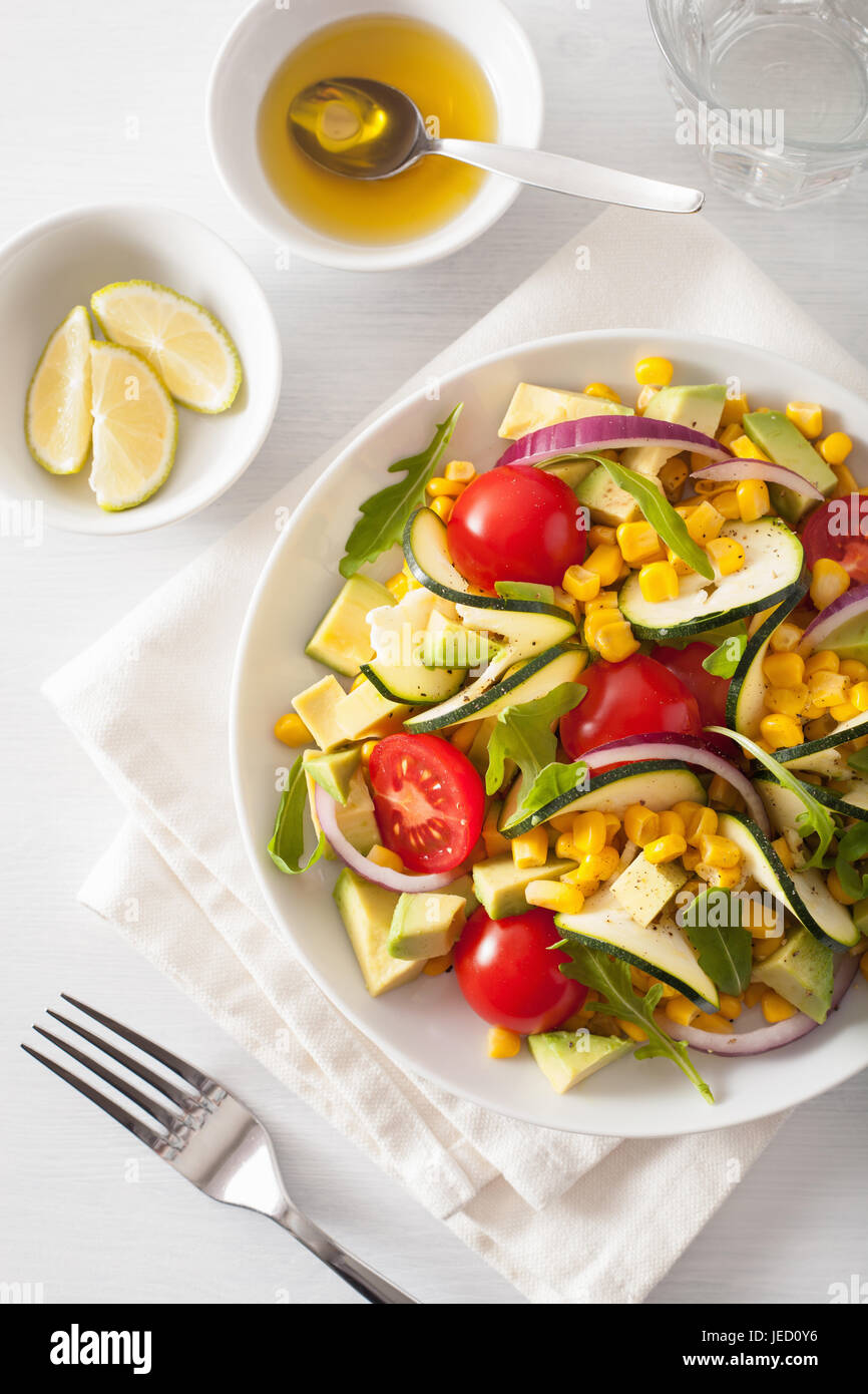 spiralized courgette salad with sweetcorn tomato avocado, healthy vegan meal Stock Photo