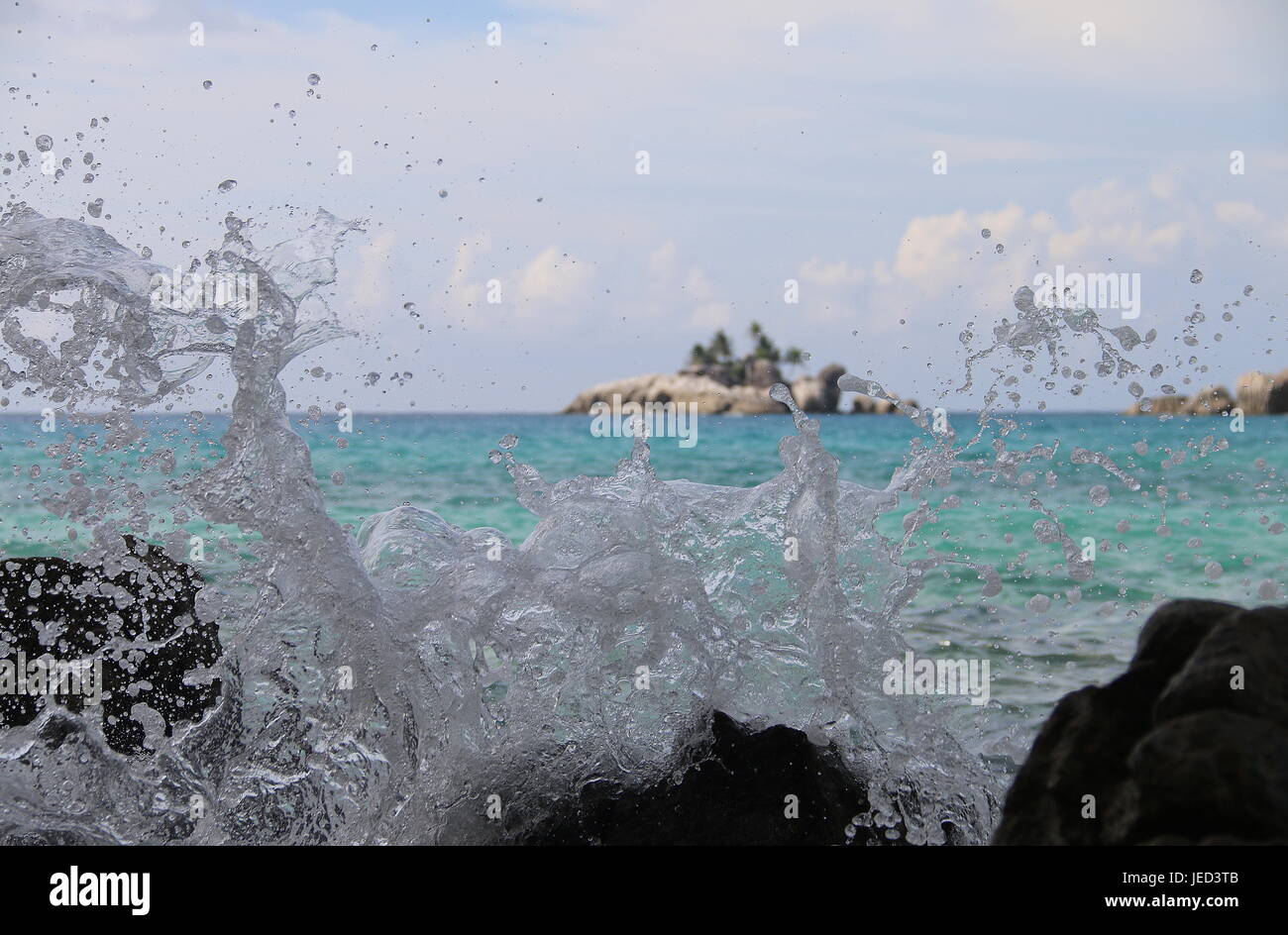Far away island seen through surf Stock Photo Alamy