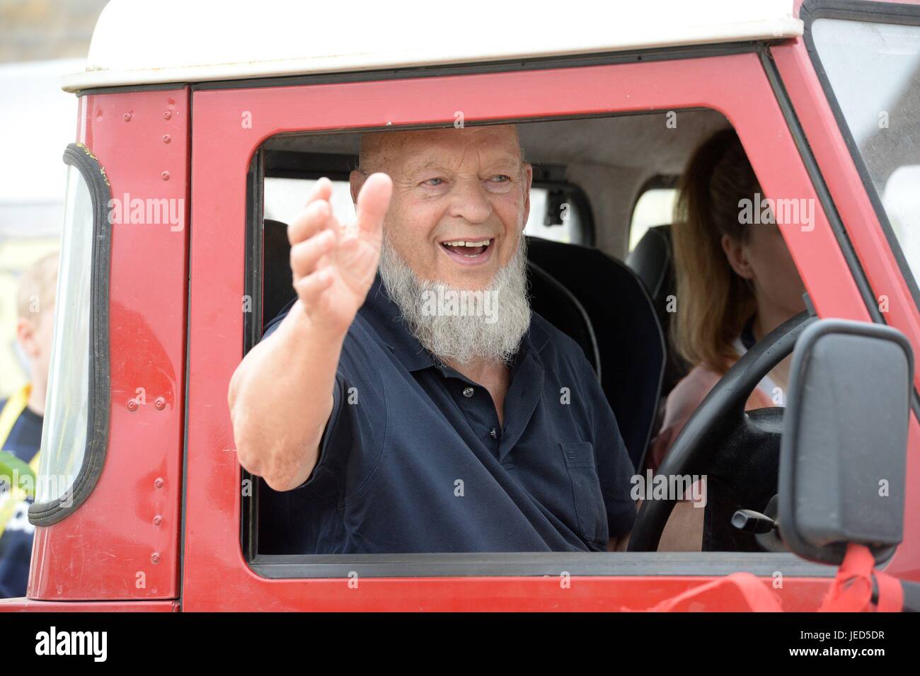 Michael Eavis celebrates a completed house in a housing development in