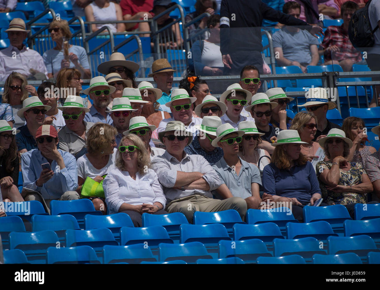 The Queen's Club, London, UK. 23rd June, 2017. Day 5 of the 2017 Aegon Championships, centre court action with Sam Querry (USA) v Gilles Muller (LUX). Spectators with corporate straw hats. Credit: Malcolm Park/Alamy Live News. Stock Photo