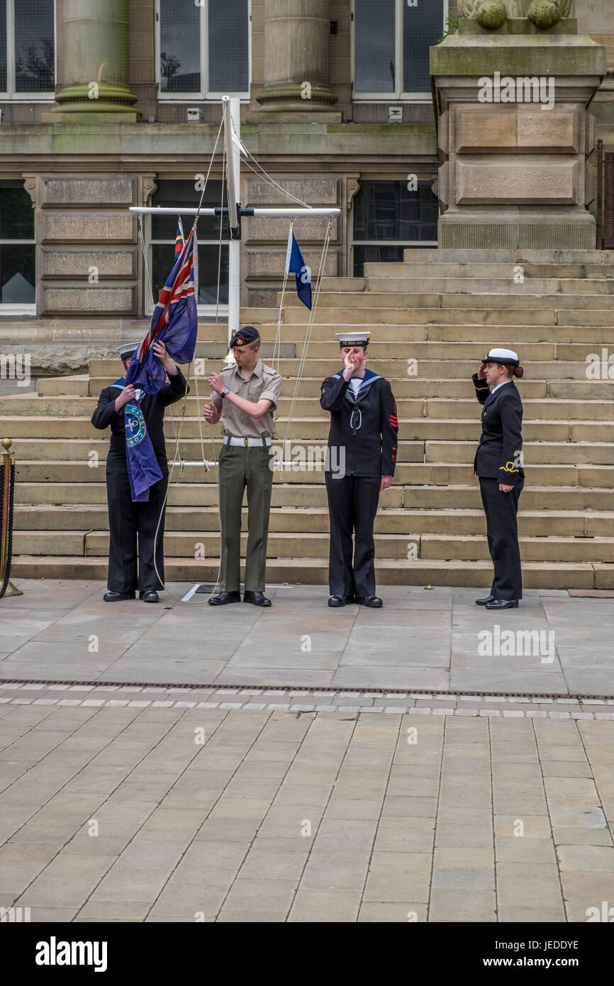 Bolton, Greater Manchester, England, UK 24th June 2017. Armed Forces Day celebrated in Bolton Town Centre with three of the forces present, Army Navy and Airforce,  The navy raised the standard just before 11:00 hours.  The groups all martched into position awaiting the arrival of the Vicar of Bolton, Bolton Mayor and other dignitaries, they all stood on the town hall steps where the vicar of Bolton conducted a small service in commemoration of the lives lost in various conflicts around the world. Credit: Mike Hesp/Alamy Live News Stock Photo
