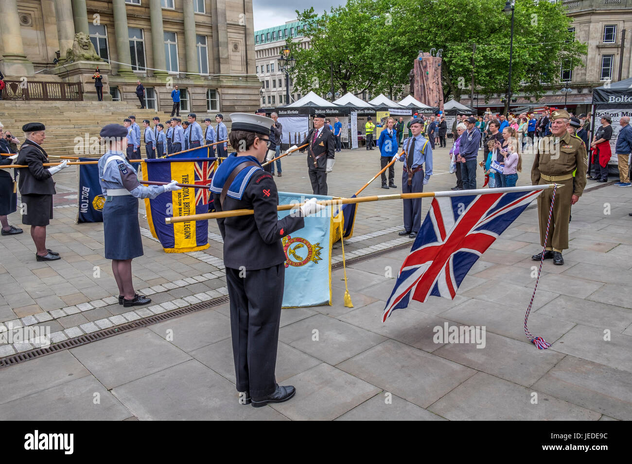 Bolton, Greater Manchester, England, UK 24th June 2017. Armed Forces Day celebrated in Bolton Town Centre with three of the forces present, Army Navy and Airforce,  The navy raised the standard just before 11:00 hours.  The groups all martched into position awaiting the arrival of the Vicar of Bolton, Bolton Mayor and other dignitaries, they all stood on the town hall steps where the vicar of Bolton conducted a small service in commemoration of the lives lost in various conflicts around the world. Credit: Mike Hesp/Alamy Live News Stock Photo