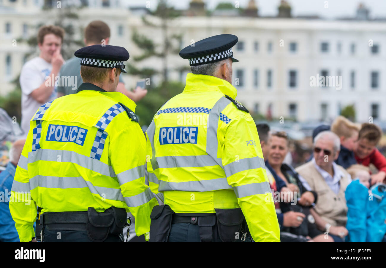 Pair of British police offers patrolling an event in England, UK. Stock Photo