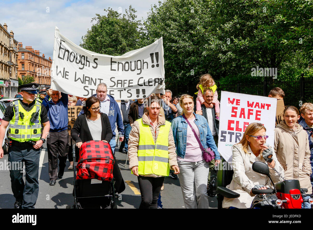 Glasgow, UK. 24th June, 2017. LIZ CROSBIE and FRANCES STOJILKOVIC from Govanhill Community Campaign lead a protest march of several hundred local residents through Govanhill, Glasgow to NICOLA STURGEON's (MSP and Scotland's First Minister) constituency office to hand in a petition demanding action be taken to make the streets safer and cleaner. This was the latest action in a long standing campaign trying to involve and get action from NICOLA STURGEON, who was unavailable and the petition was received by MHAIRI HUNTER, an SNP local counsellor on her behalf. Credit: Findlay/Alamy Live News Stock Photo