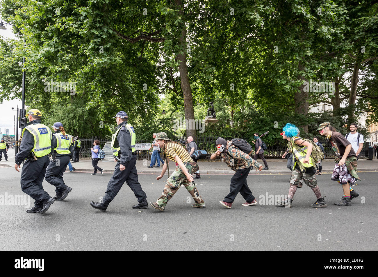 London, UK. 24th June, 2017. Anti-fascist activists dressed as clowns humorously follow and taunt the police prior to the EDL rally. Anti-Fascist groups including Unite Against Fascism (UAF) clash with police with some arrests being made whilst counter-protesting the far-right British nationalist group English Defence League (EDL) during their “march against terrorism” in light of the recent city terror attacks. Credit: Guy Corbishley/Alamy Live News Stock Photo