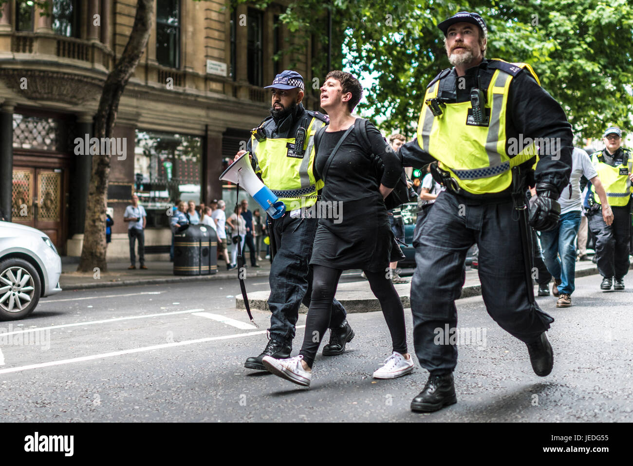 London, UK, 24th June 2017. Unite Against Fascism (UAF) has organized a demonstration near Trafalgar Square against the English Defence League (EDL).  Woman being arrested. Due to recent terrorist attacks, there’s a heavy police presence. Credit: onebluelight.com/Alamy Live News Credit: onebluelight.com/Alamy Live News Stock Photo