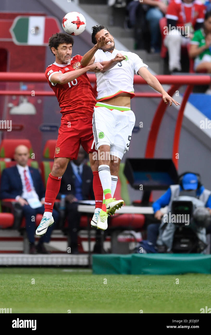 Kazan, Russia. 24th June, 2017. Mexico's Diego Reyes (R) and Russia's Yuri Shirkov vie for the ball during the group stage match pitting Mexico against Russia at the Kazan Arena in Kazan, Russia, 24 June 2017. Photo: Marius Becker/dpa/Alamy Live News Stock Photo