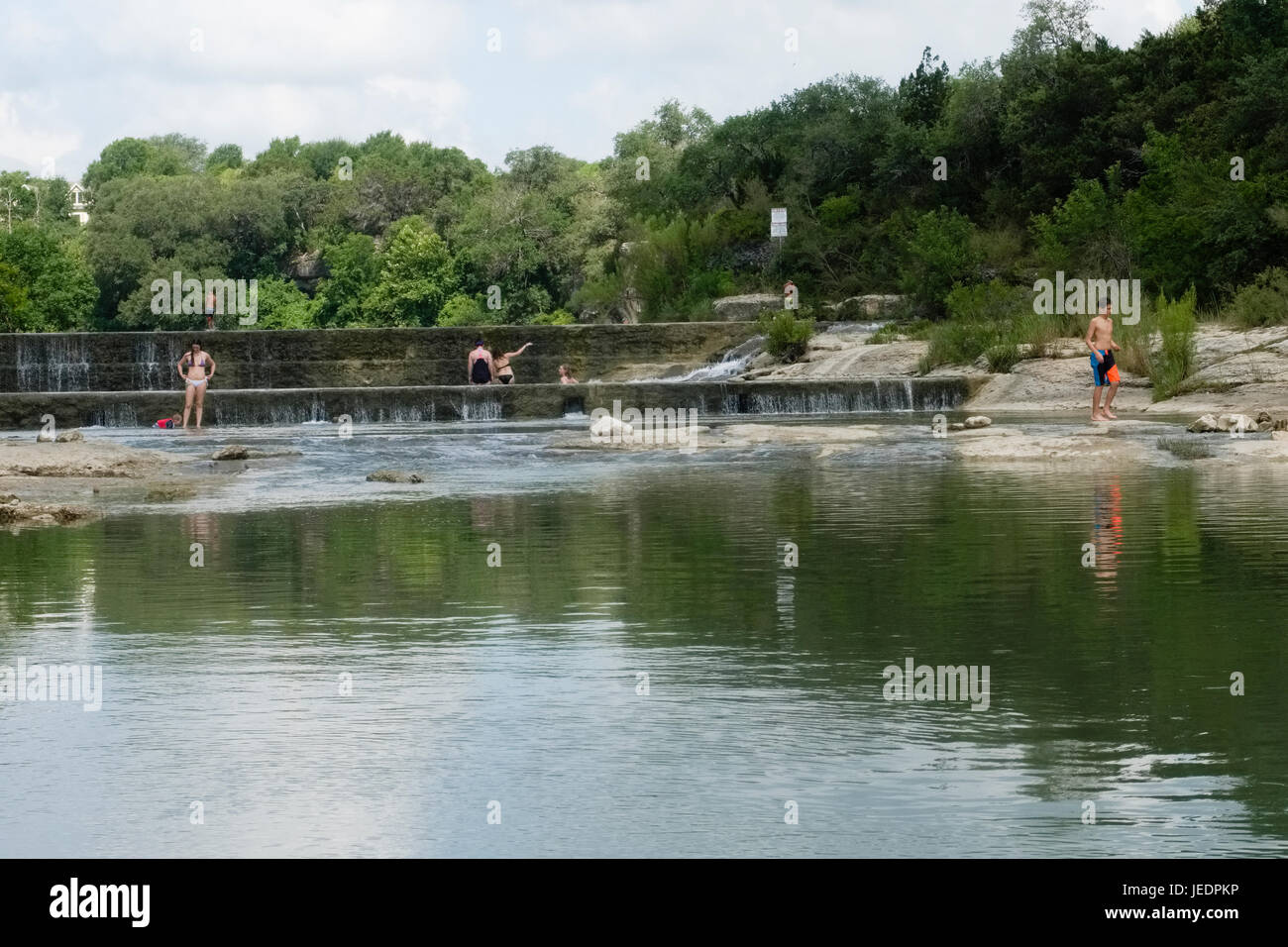 Swimming in a local community swimming hole known as Blue Hole on the San Gabriel River in Georgetown, Texas USA Stock Photo