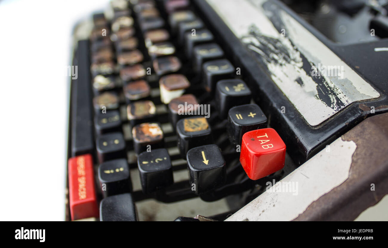 old and rusty dirty typewriter. viewed from the side. tab button is in the foreground completely focused Stock Photo