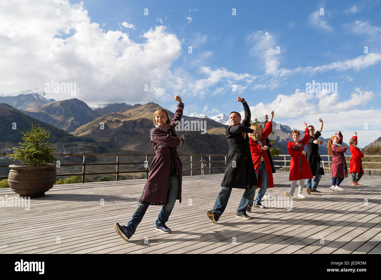 Georgian people in local dresses perform georgian folk dance, Georgia, Caucasus Mountains. Stock Photo