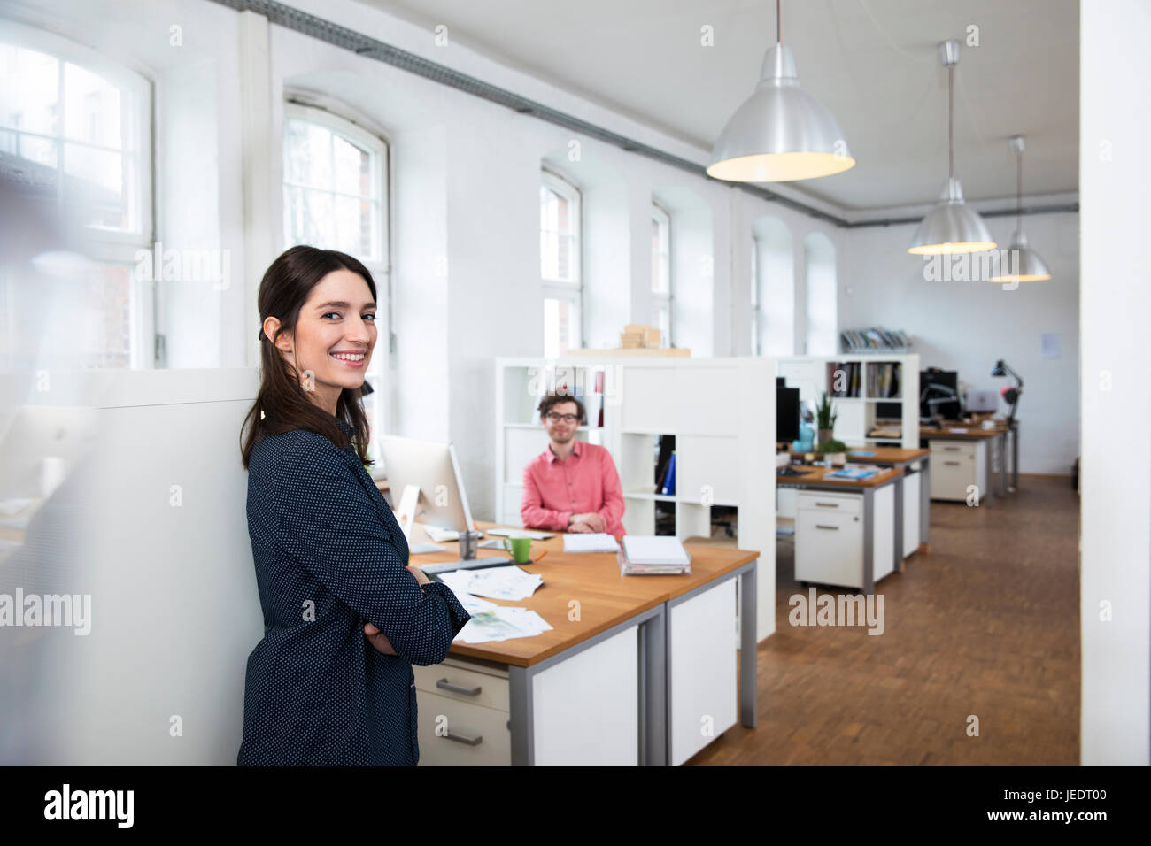 Portrait of smiling woman and man in office Stock Photo - Alamy
